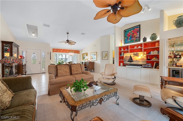 living room featuring lofted ceiling, light tile patterned flooring, and ceiling fan