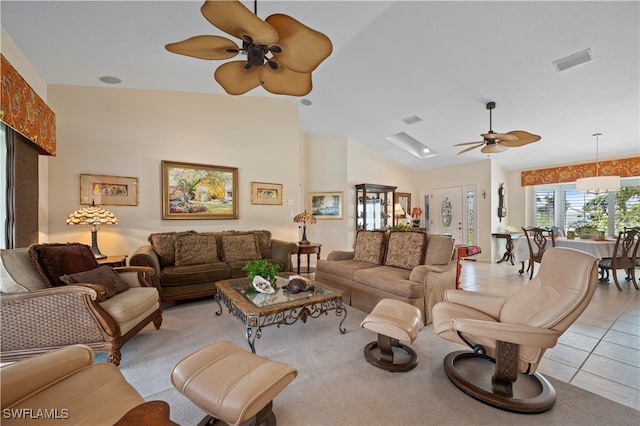 tiled living room featuring ceiling fan and vaulted ceiling