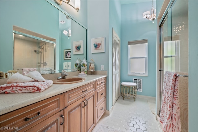 bathroom with vanity, walk in shower, tile patterned floors, and an inviting chandelier