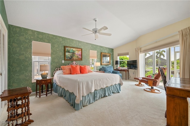 bedroom featuring lofted ceiling, ceiling fan, and light carpet