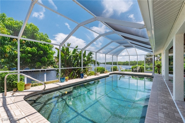 view of swimming pool featuring a lanai, a patio area, and a water view