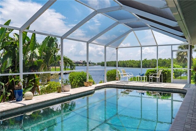 view of swimming pool featuring a patio, a water view, and glass enclosure