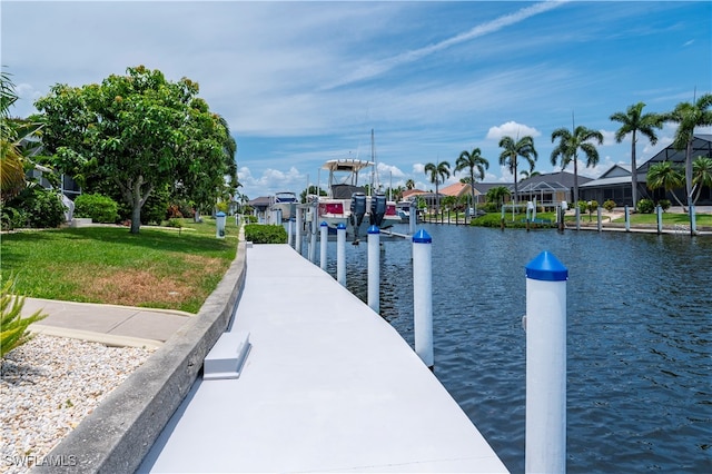 dock area with a yard and a water view