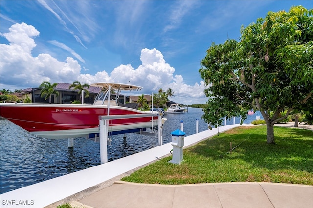 dock area featuring a water view and a lawn