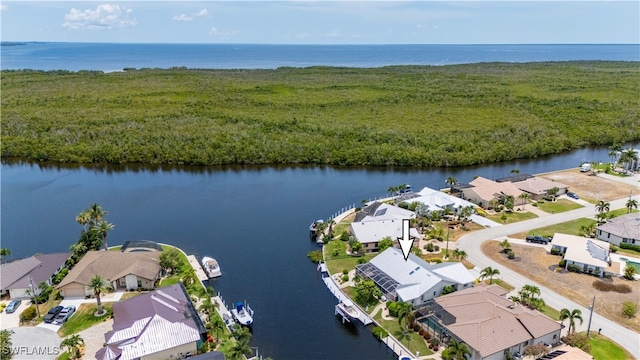 birds eye view of property with a water view