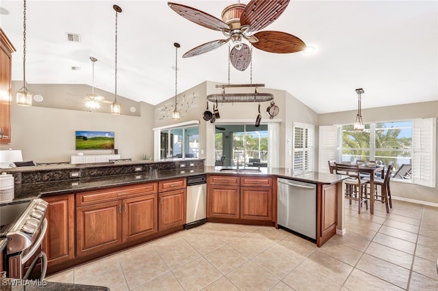 kitchen featuring light tile patterned floors, stainless steel appliances, ceiling fan, decorative light fixtures, and dark stone counters