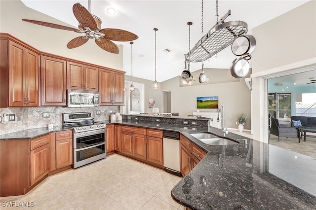 kitchen featuring ceiling fan, hanging light fixtures, sink, high vaulted ceiling, and stainless steel appliances