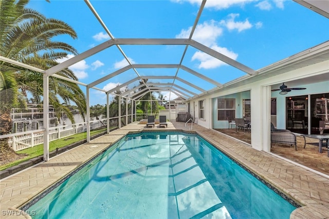 view of pool featuring a patio, a lanai, and ceiling fan