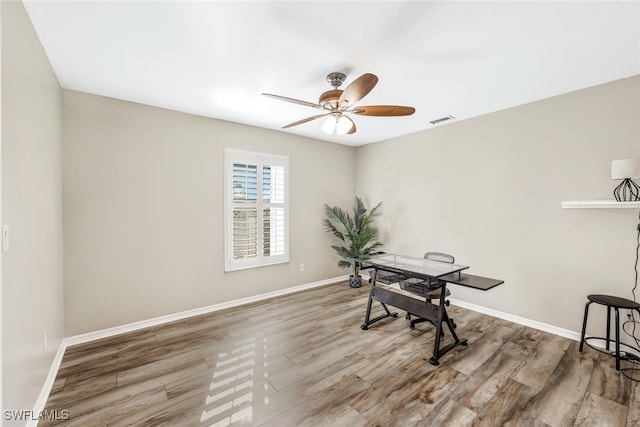 office space with wood-type flooring and ceiling fan