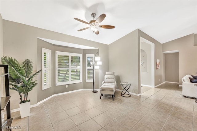 sitting room with light tile patterned floors, lofted ceiling, and ceiling fan