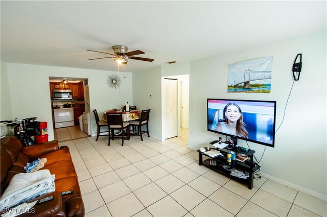 tiled living room with ceiling fan