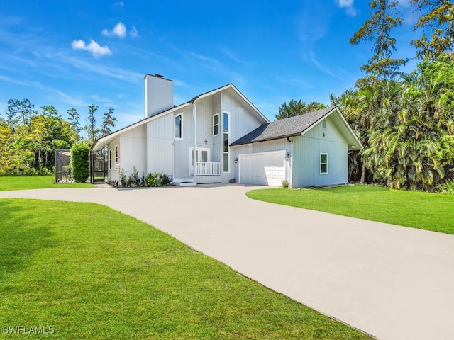 view of front of property with a front yard and a garage