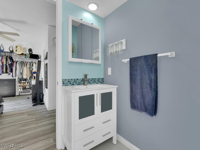 bathroom featuring wood-type flooring, ceiling fan, and vanity