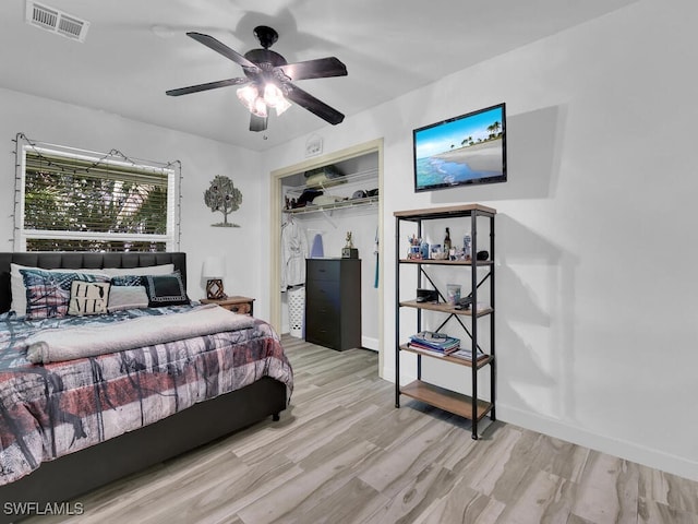 bedroom with a closet, light wood-type flooring, and ceiling fan