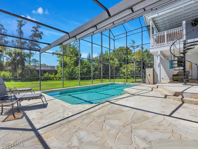 view of swimming pool with a lanai, a yard, and a patio area