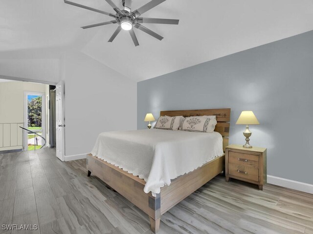 bedroom with ceiling fan, vaulted ceiling, and light hardwood / wood-style floors