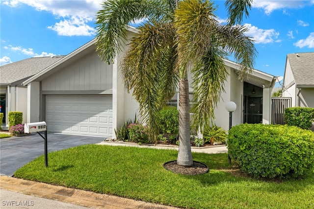 view of front of home featuring a garage and a front lawn