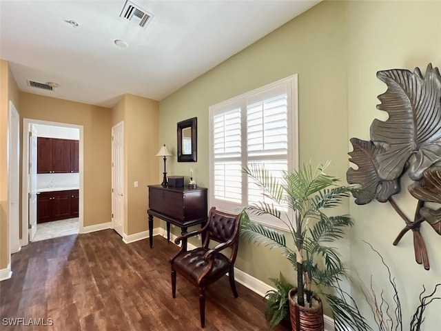 sitting room with dark wood-type flooring