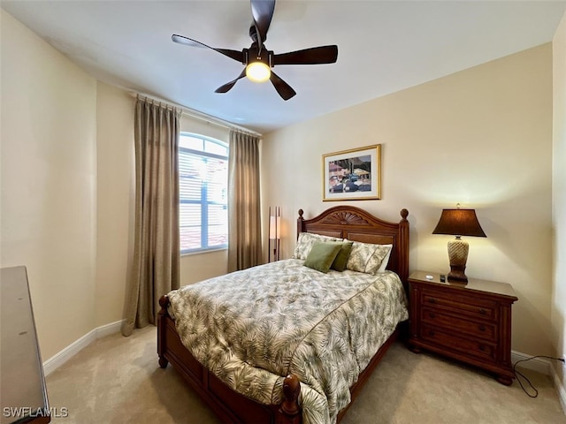 bedroom featuring ceiling fan and light carpet