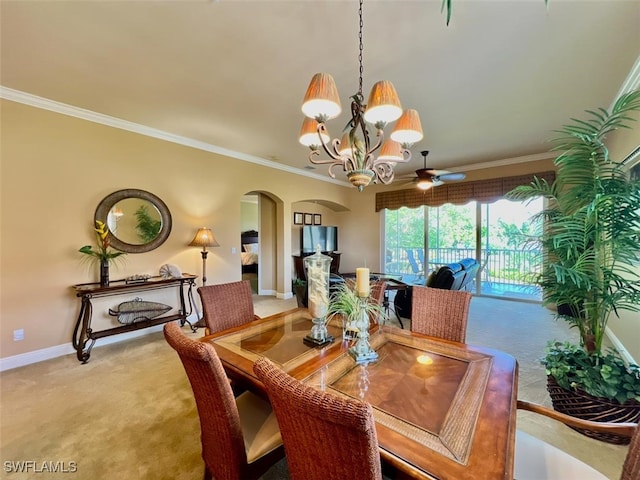 dining room featuring ceiling fan with notable chandelier, carpet floors, and ornamental molding