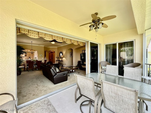 view of patio with exterior bar and ceiling fan