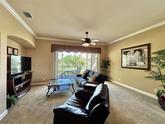 carpeted living room with ornamental molding and ceiling fan