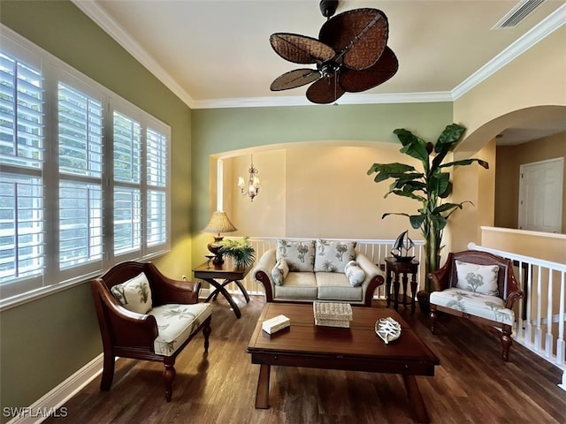 sitting room featuring ceiling fan with notable chandelier, dark hardwood / wood-style flooring, and ornamental molding