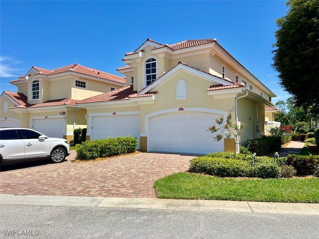 mediterranean / spanish house featuring a garage