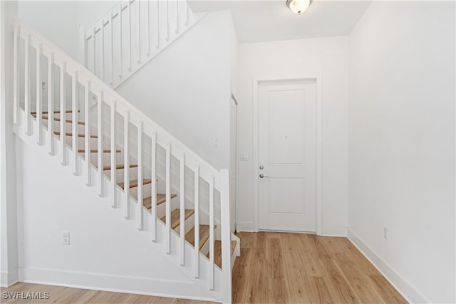 stairs with hardwood / wood-style flooring