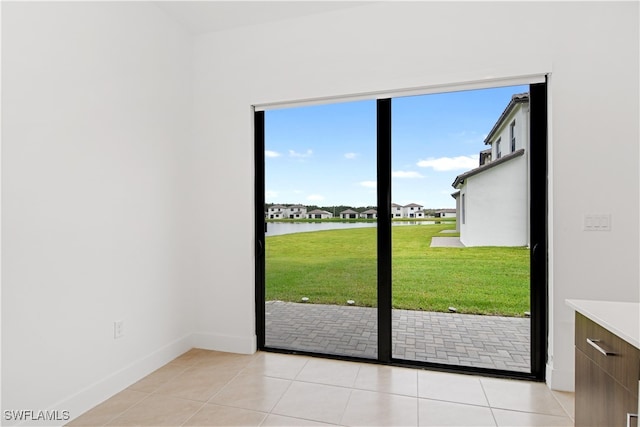 entryway with a water view and light tile patterned floors