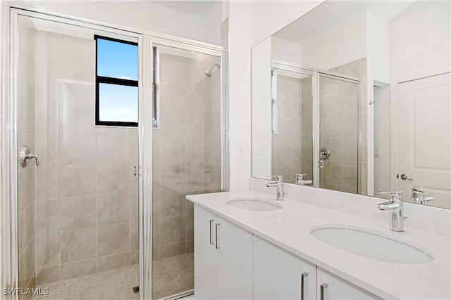 bathroom featuring walk in shower and vanity