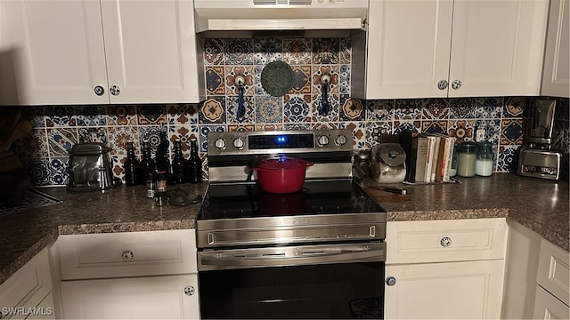 kitchen with tasteful backsplash, white cabinetry, and stainless steel range with electric cooktop