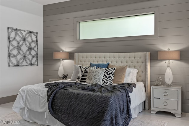 bedroom with wood walls