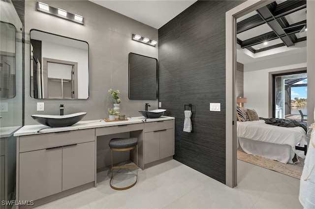 bathroom featuring tile patterned floors, vanity, coffered ceiling, and tile walls