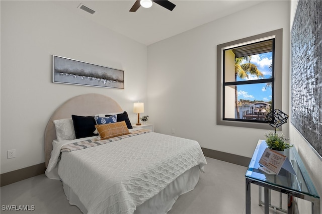 bedroom with ceiling fan and concrete floors