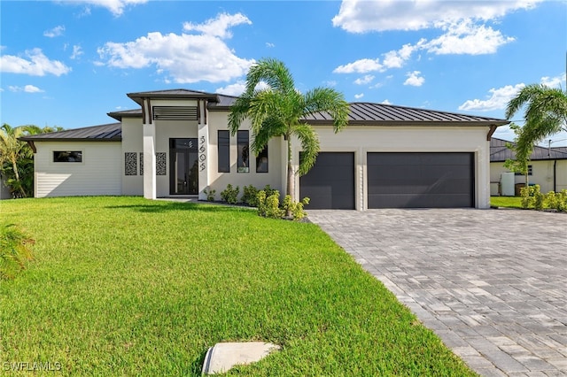 view of front of house with a garage and a front lawn