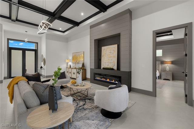 living room with coffered ceiling, beam ceiling, and a fireplace