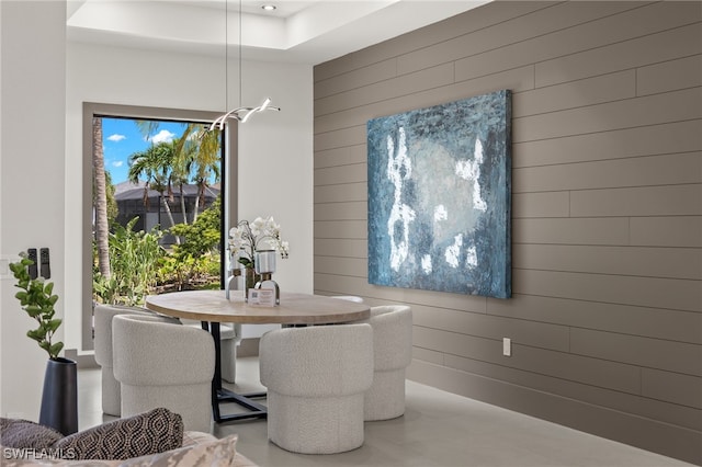 dining space featuring wooden walls