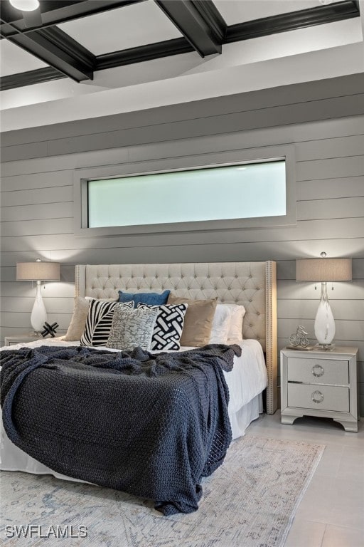 bedroom featuring coffered ceiling, beam ceiling, wooden walls, and multiple windows