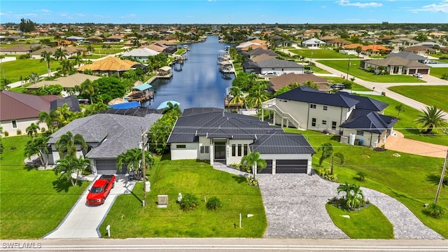 birds eye view of property with a water view