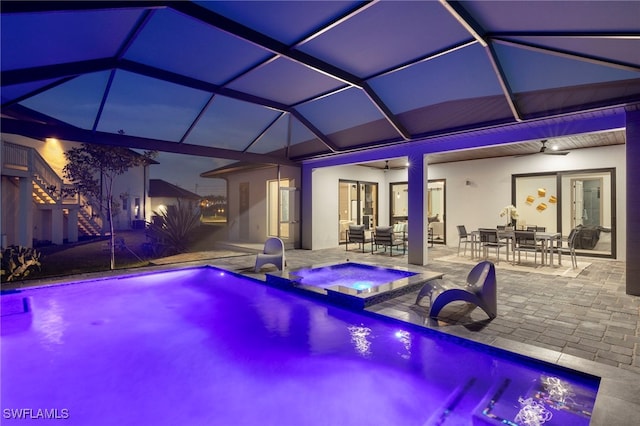 view of pool featuring a lanai, an in ground hot tub, ceiling fan, and a patio area