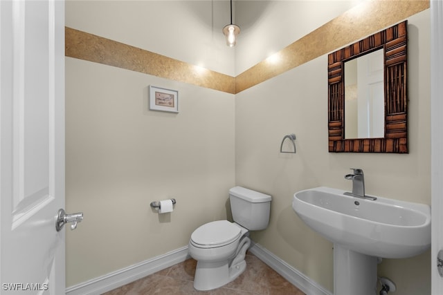 bathroom featuring tile patterned floors, toilet, and sink