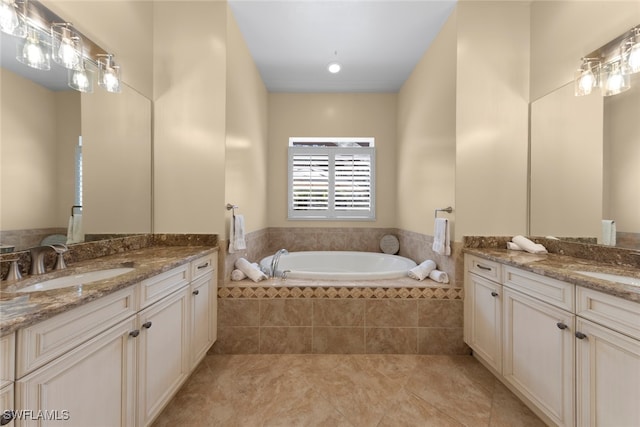 bathroom featuring vanity, tiled bath, and tile patterned floors