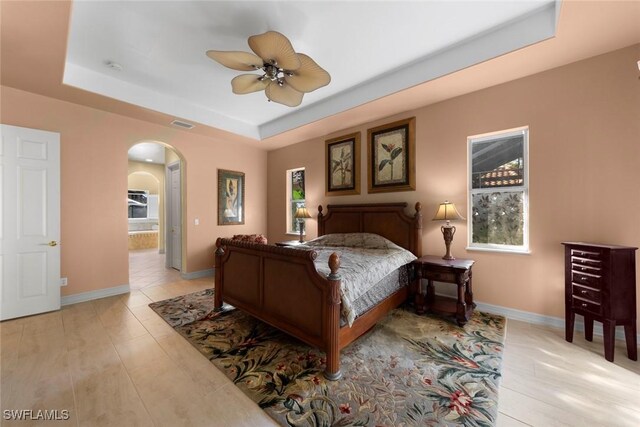 bedroom featuring a tray ceiling and ceiling fan