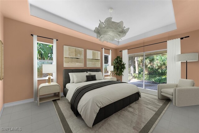 tiled bedroom with access to exterior, a chandelier, a raised ceiling, and multiple windows