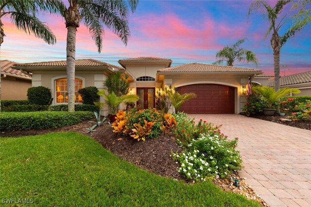 mediterranean / spanish home featuring a garage