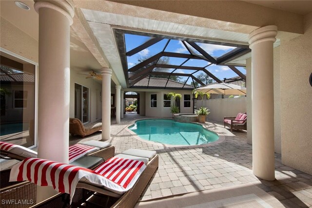 view of pool with a patio, ceiling fan, and a lanai