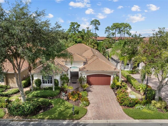 mediterranean / spanish home with a garage