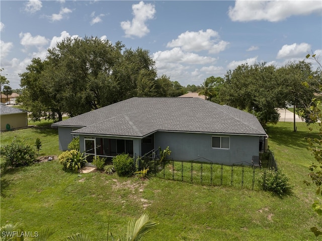 rear view of house with a yard