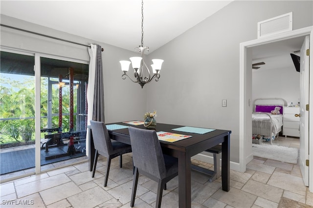 dining area featuring vaulted ceiling and ceiling fan with notable chandelier